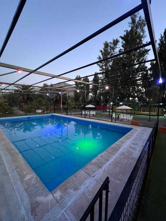 a large swimming pool with blue water at Paradise Rose’s in Talagante