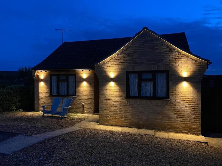 a house with lights on the side of it at Binks Bungalow in New Hunstanton