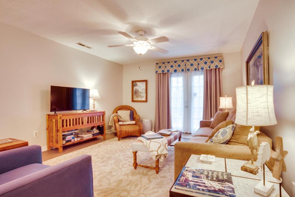 a living room with a couch and a tv at Beaufort Home with Patio 3 Mi to Downtown! in Beaufort