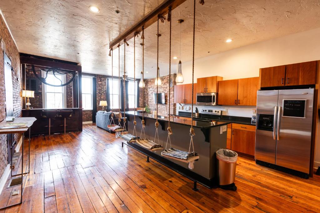 a large kitchen with wooden floors and stainless steel appliances at The Two Story Loft in Springfield