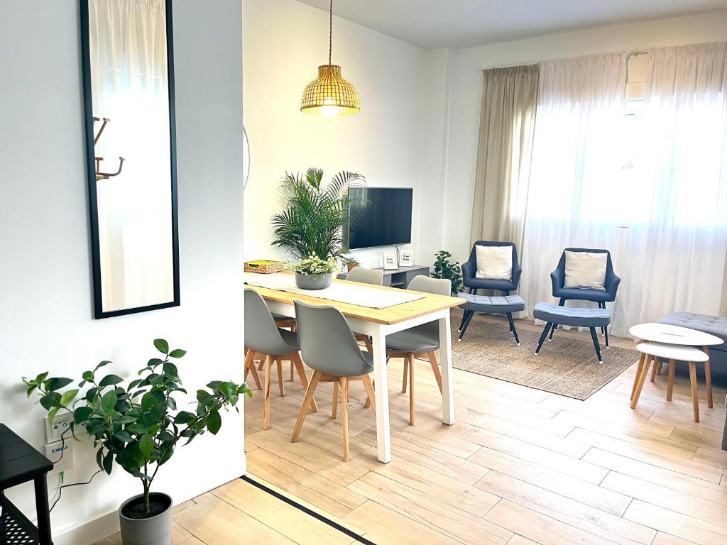 a dining room and living room with a table and chairs at Regimiento 2, center, new, quite, breakfast included, parking on request, RG in Málaga