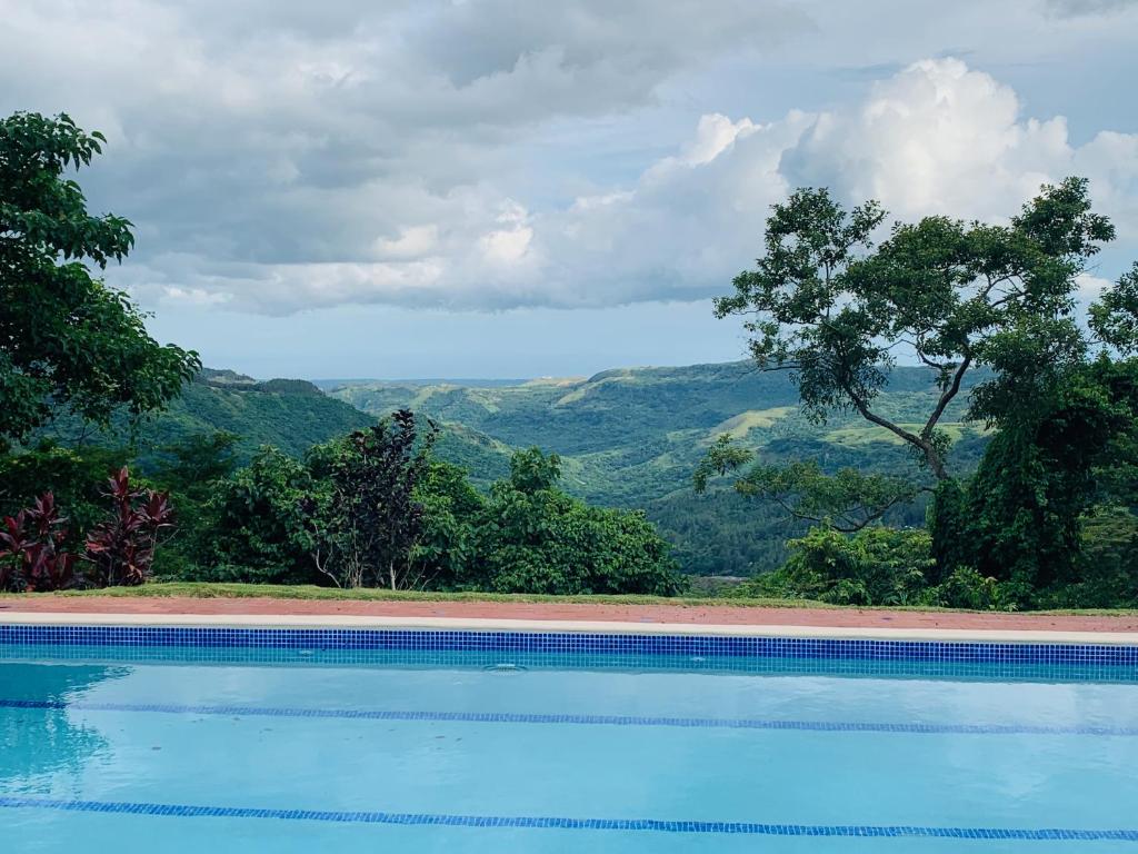 a swimming pool with a view of the mountains at Enjoy Mountain Retreat Close to Panama Beaches in Chame