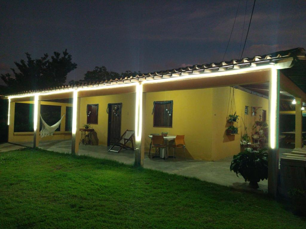 a house with lights on the side of it at night at Chalé Santa Rita in Bonito