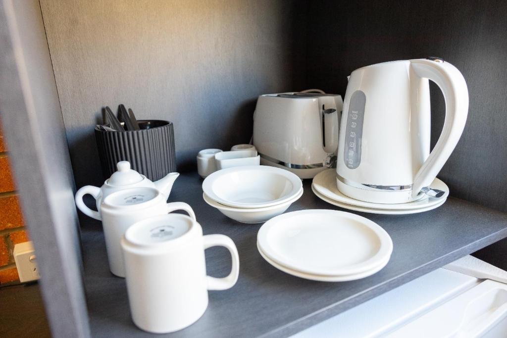 Příslušenství pro přípravu čaje a kávy v ubytování The Club Hotel