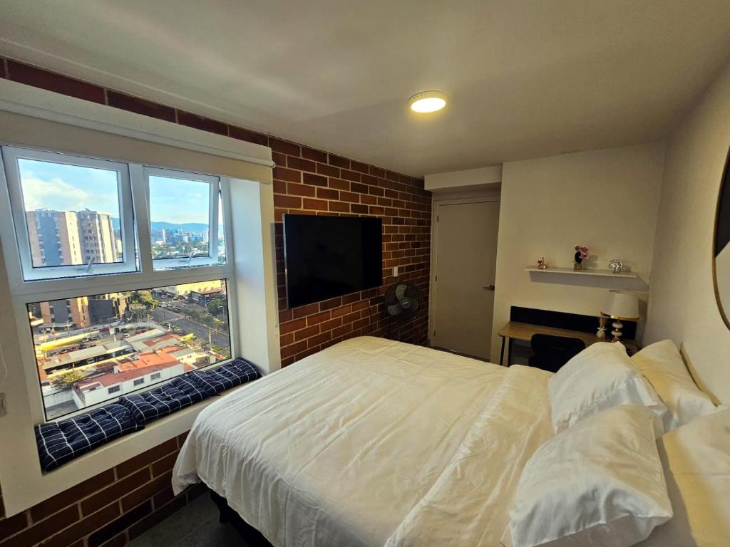 En eller flere senge i et værelse på Nuevo y Moderno apartamento en la atractiva Zona 4