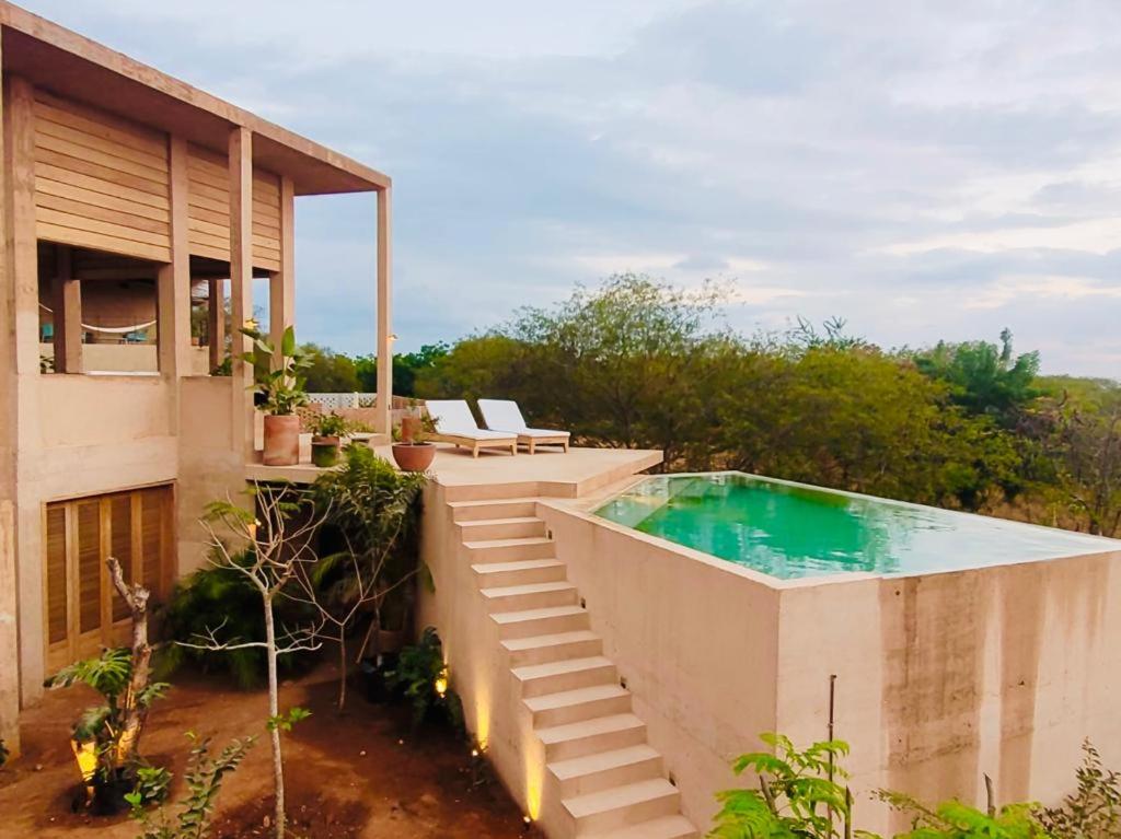 a swimming pool on the side of a house at Casa Naya in Puerto Escondido