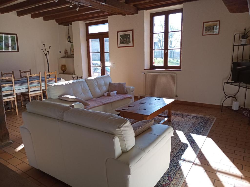 a living room with two couches and a table at Gîte Arthon, 5 pièces, 8 personnes - FR-1-591-372 in Arthon