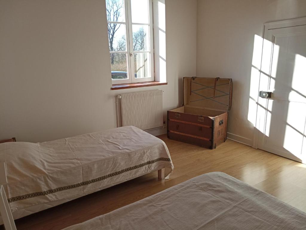 a bedroom with two beds and a dresser and a window at Gîte Arthon, 5 pièces, 8 personnes - FR-1-591-372 in Arthon