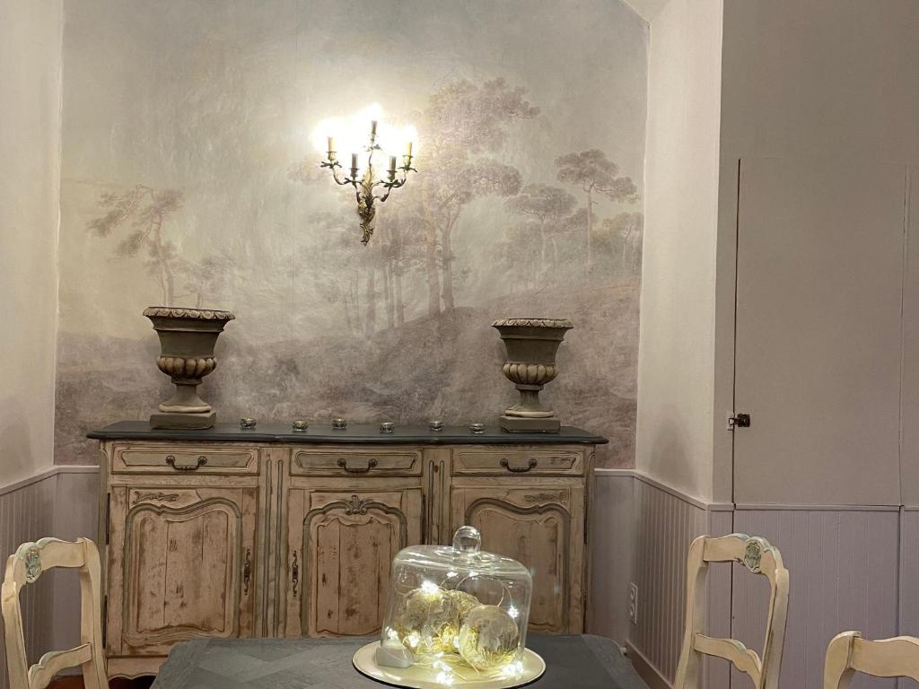 a dining room with a table and a chandelier at Gîte Bazouges-sur-le-Loir, 6 pièces, 10 personnes - FR-1-410-377 in Bazouges-sur-le-Loir