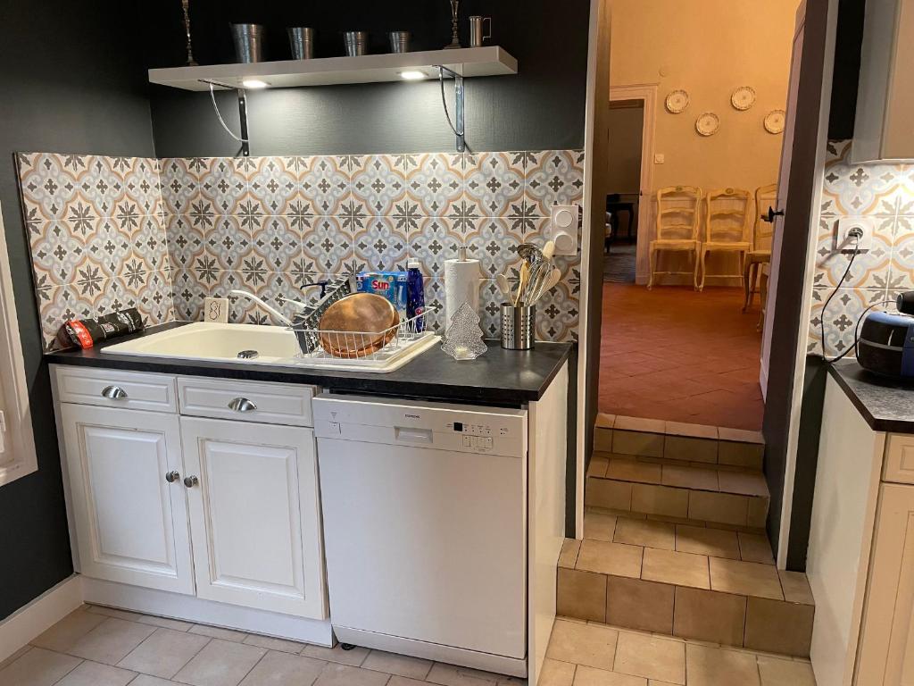 a kitchen with a sink and a counter top at Gîte Bazouges-sur-le-Loir, 6 pièces, 10 personnes - FR-1-410-377 in Bazouges-sur-le-Loir