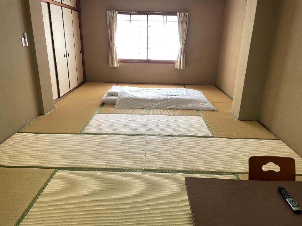 宍粟市にあるHotel Nissin Kaikan - Vacation STAY 02349vの窓の前の床に4枚のマットレスが備わる客室です。