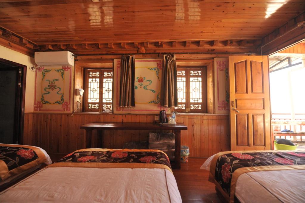 Postel nebo postele na pokoji v ubytování TIBET Guest house 虎跳峡卓玛客栈