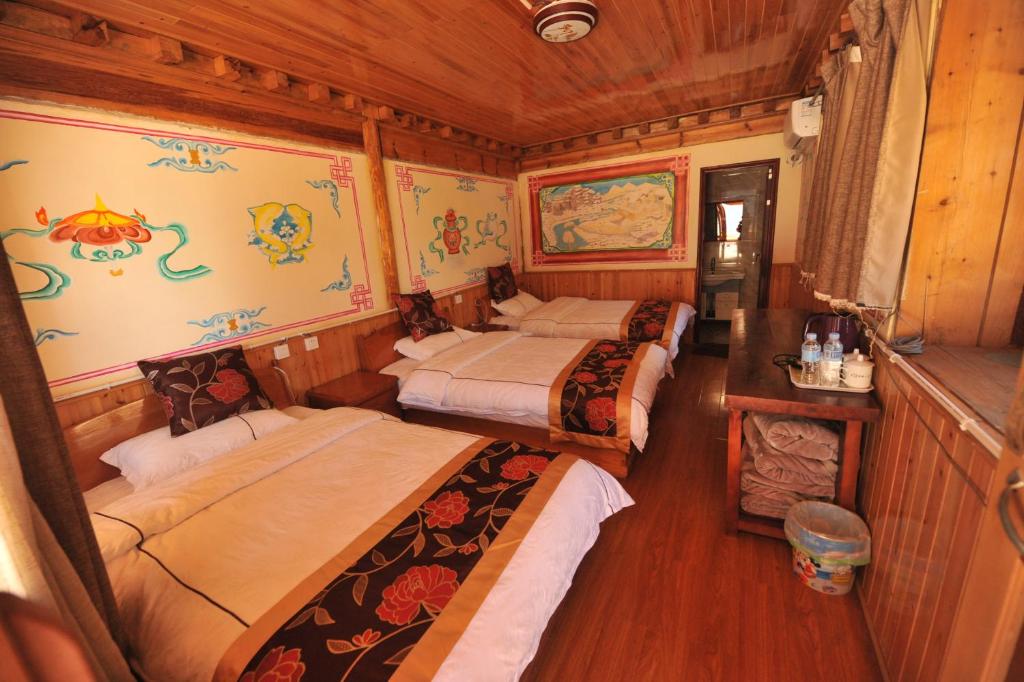 Postel nebo postele na pokoji v ubytování TIBET Guest house 虎跳峡卓玛客栈