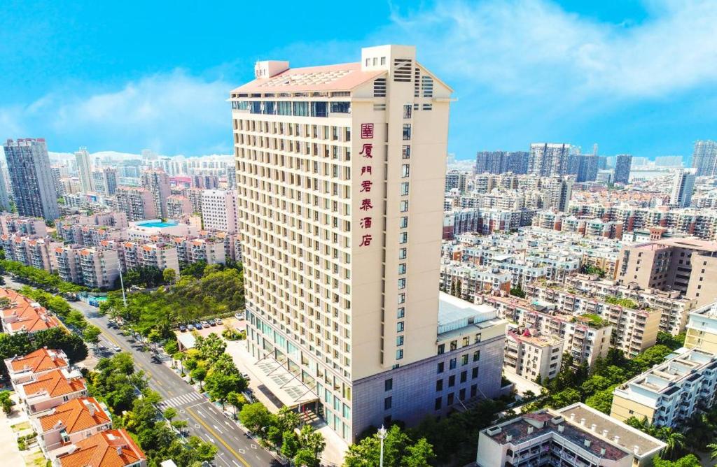 an aerial view of a tall building in a city at Juntai Hotel Xiamen in Xiamen