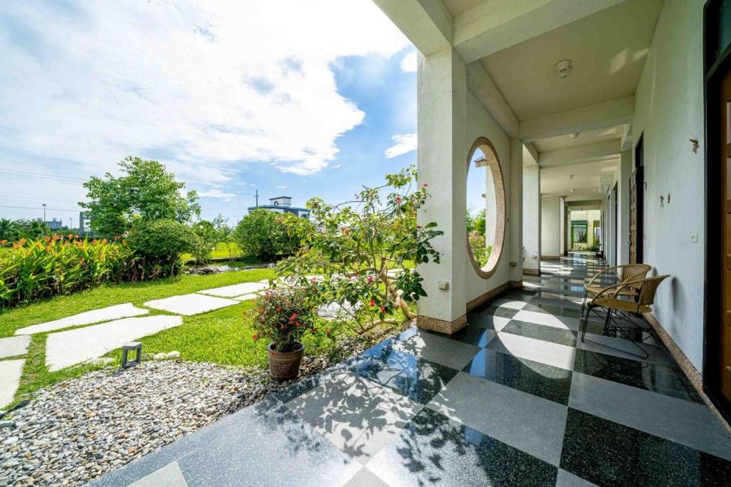 a house with a patio with a garden at Yun Tien Feng Chuan B&amp;B in Dongshan