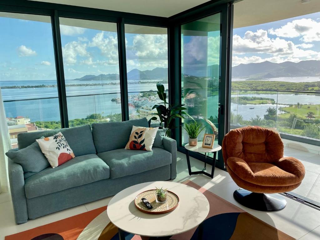 salon z kanapą i krzesłem w obiekcie Gorgeous 2 bedroom, 17th floor, with breathtaking view, Fourteen at Mullet Bay w mieście Cupecoy