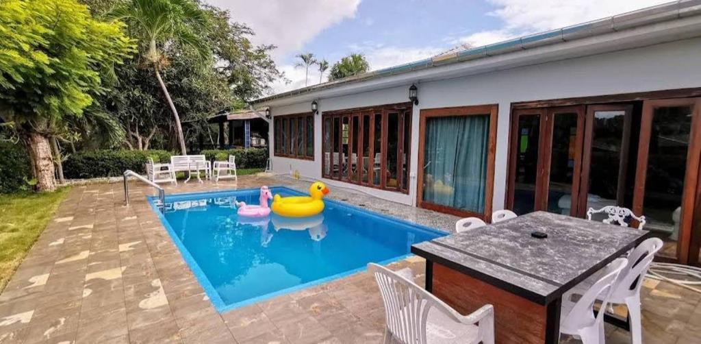 a swimming pool with a rubber duck in a house at Rock Garden Beach D19 Pool Villa in Rayong