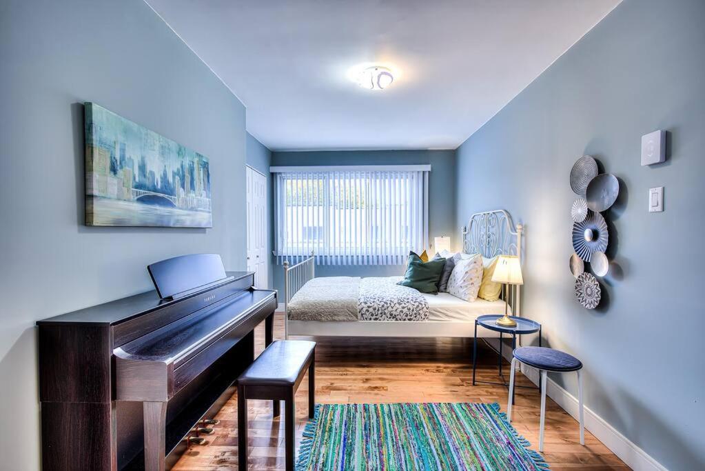 a bedroom with a piano and a bed in it at Charming 2BR with Balcony in Montreal in Montreal