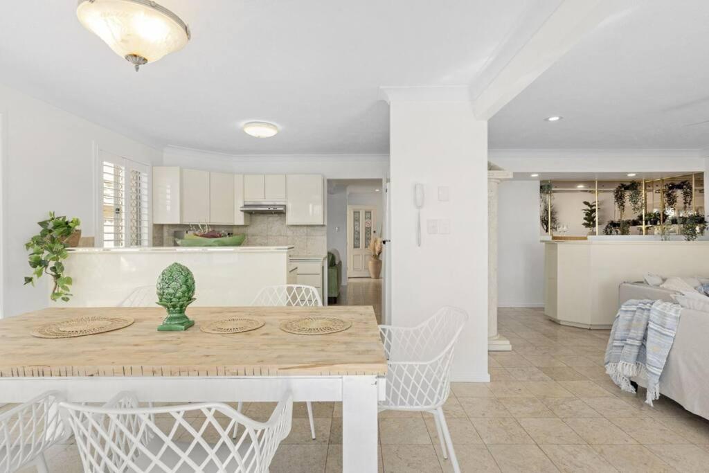 a kitchen and dining room with a table and chairs at 64 Isle of Palms in Gold Coast