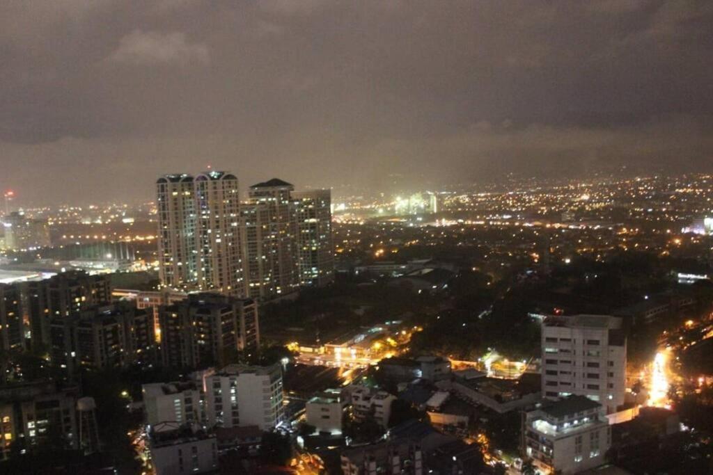 a view of a city at night with lights at Simple Ortigas Suite w/ City View, & Pool 3017 in Manila