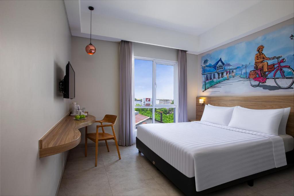 Postel nebo postele na pokoji v ubytování favehotel Sidoarjo