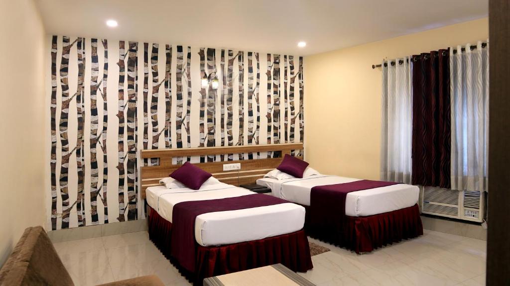 Postel nebo postele na pokoji v ubytování Hotel Executive Tower