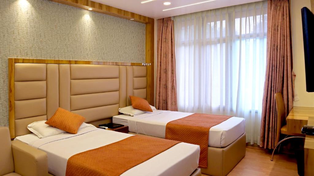 Postel nebo postele na pokoji v ubytování Hotel Executive Tower