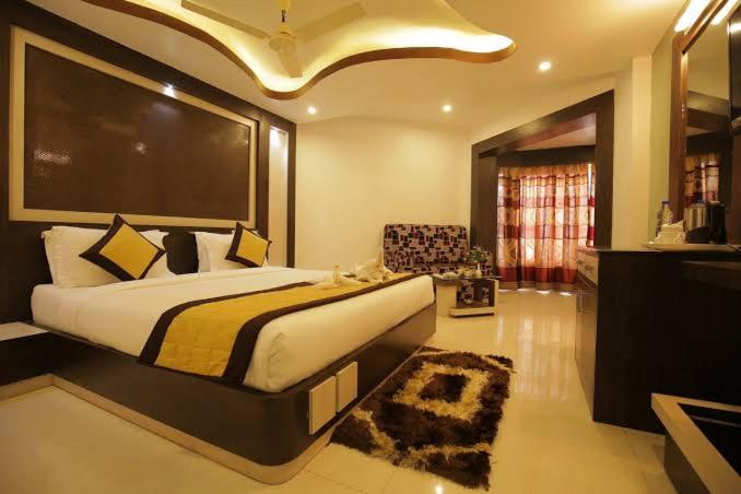 a bedroom with a large bed in a room at Hotel Goa Heritage Resort in Baga