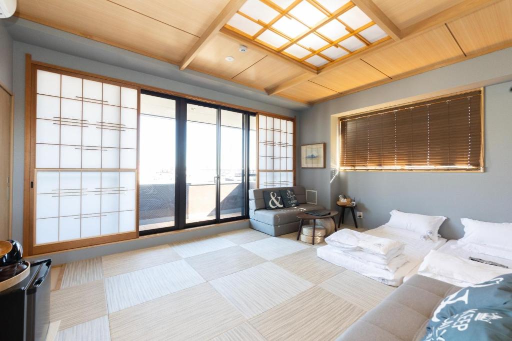 a living room with a couch and large windows at Light Hotel - Vacation STAY 17340v in Tokyo