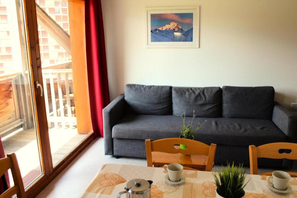 a living room with a couch and a table at Les Chalets De Superd Gentiane - 2 Pièces pour 6 Personnes MAE-9124 in Le Dévoluy