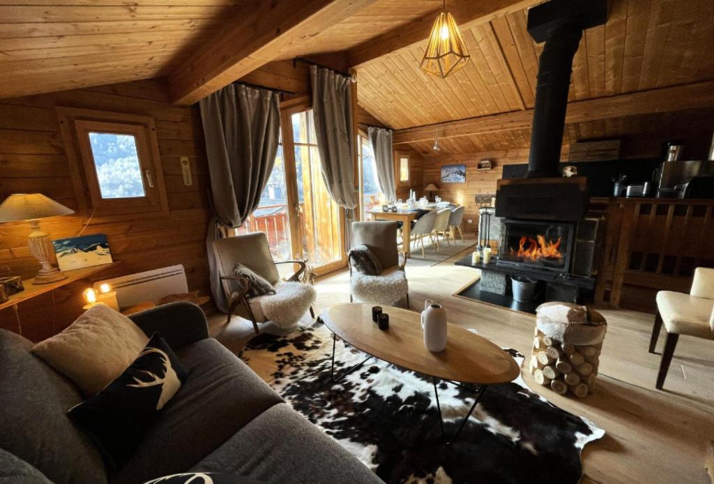 a living room with a couch and a fireplace at Chalet Nubuck - Pièces 134 in Saint-Martin-de-Belleville