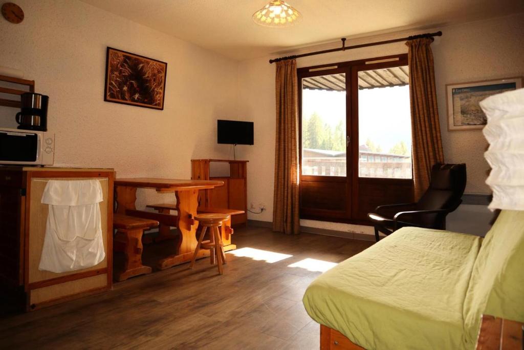 une chambre avec un lit, un bureau et une fenêtre dans l'établissement Résidence Orr Des Forets - 87 Orrianes des forets MAE-0534, aux Orres