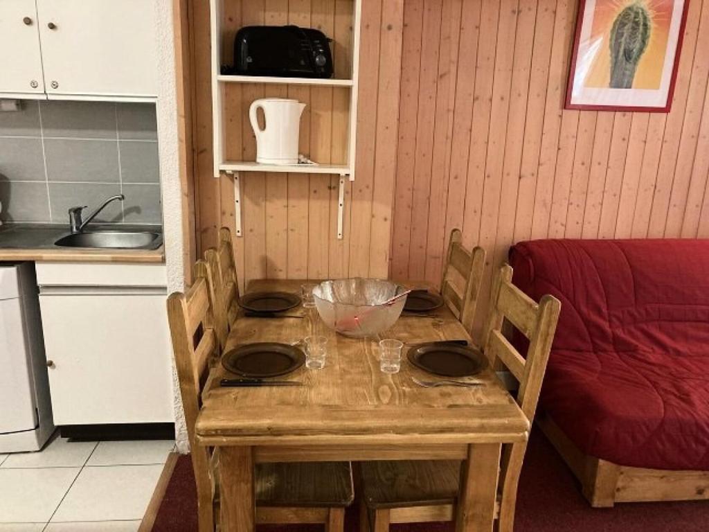 a wooden table in a kitchen with a bowl on it at Résidence Rond Point Pistes - Pièces 744 in Orcières