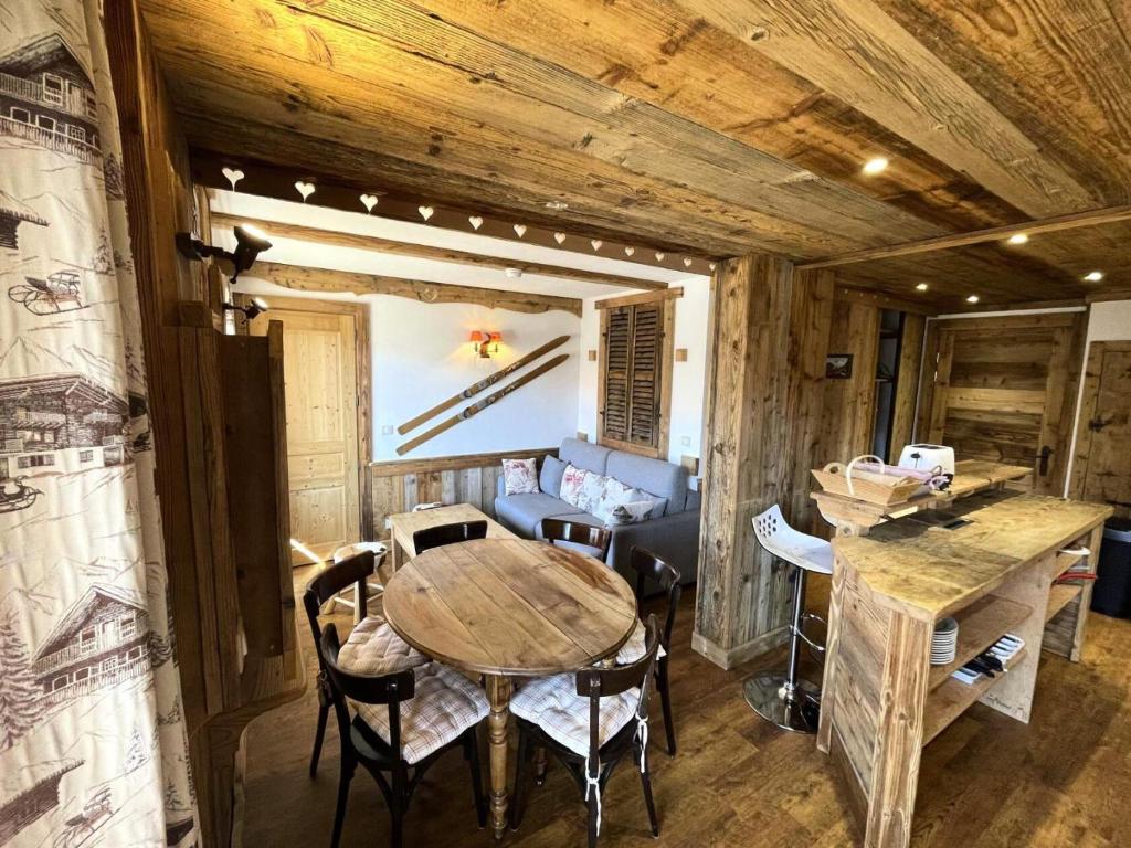 une salle à manger avec une table et des chaises en bois dans l'établissement Résidence Necou - Superbe appartement pour 6 personnes MAE-4594, aux Menuires