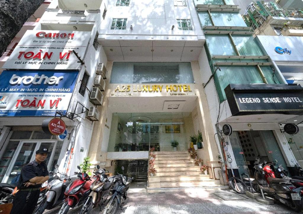 a building with motorcycles parked in front of it at A25 Hotel - 29 Bùi Thị Xuân in Ho Chi Minh City