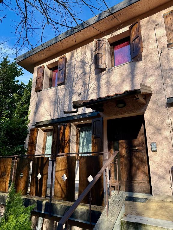 a building with wooden doors and windows on it at VIDI HOME in Vidiciatico
