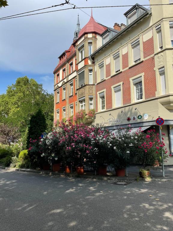 una fila di fiori di fronte a un edificio di Hotel Berg a Stoccarda