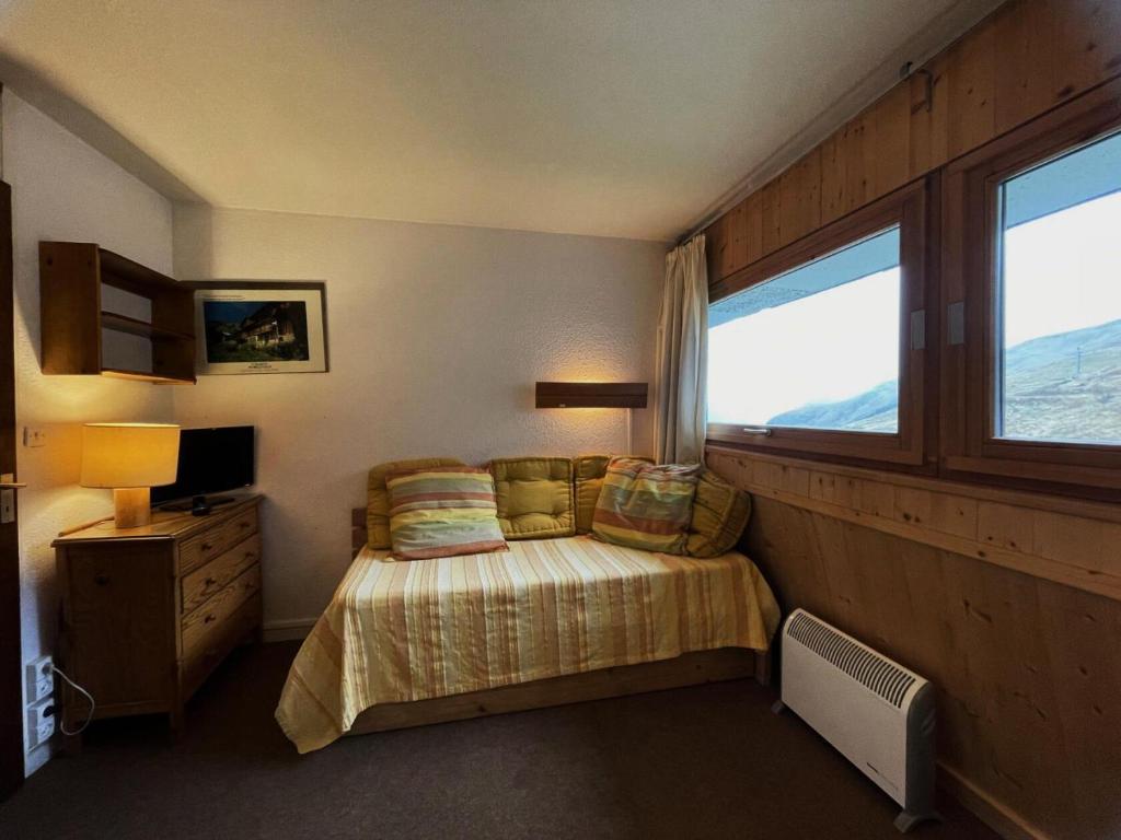 une chambre avec un lit et une fenêtre dans l'établissement Résidence Combes - Studio 2 personnes ski aux pieds aux Ménuires MAE-6024, aux Menuires