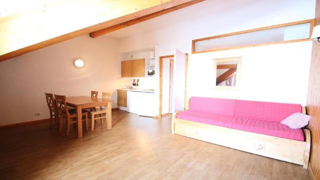 un salon avec un canapé rose et une table dans l'établissement Résidence Parc Aux Etoiles - B202PAE - APPARTEMENT 1 CHAMBRE, BALCON MAE-2444, à Narreyroux