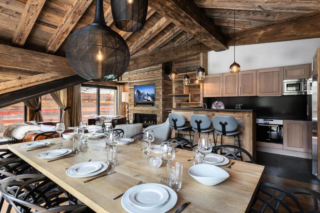 a dining room with a wooden table and chairs at Résidence Oursnoir - Chalets pour 10 Personnes 224 in Val-d'Isère