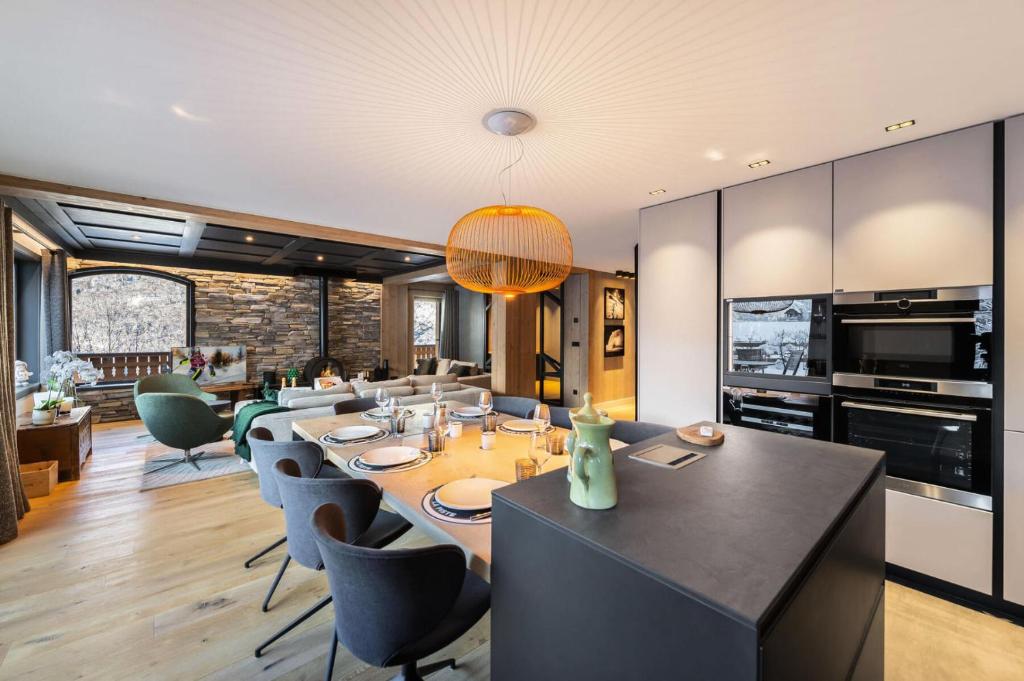 a dining room with a long table and chairs at Chalet Les Morilles - Chalets pour 10 Personnes 054 in Les Allues
