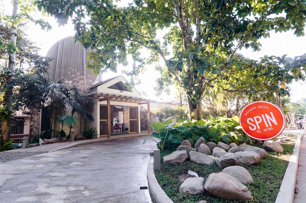 a stop sign in front of a building at Spin Designer Hostel - El Nido in El Nido