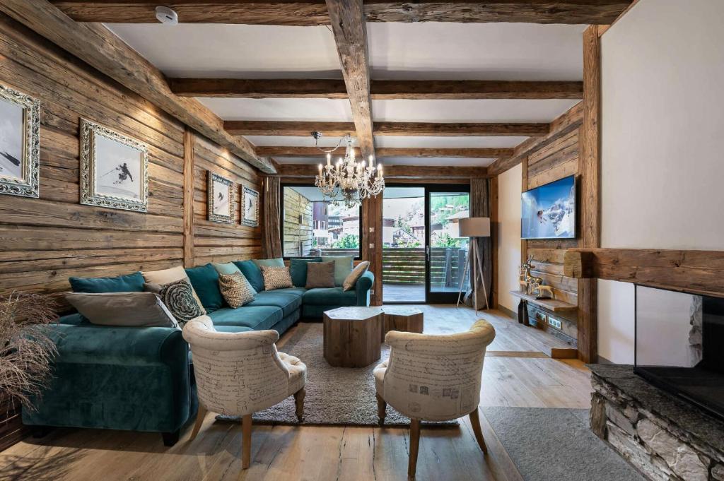 ein Wohnzimmer mit einem blauen Sofa und einem Kamin in der Unterkunft Residence Savoie - 4 Pièces pour 8 Personnes 664 in Val dʼIsère