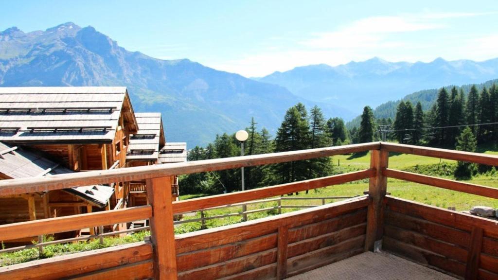 a wooden balcony with a view of mountains at Résidence Dame Blanche - 2 Pièces pour 6 Personnes 194 in Narreyroux