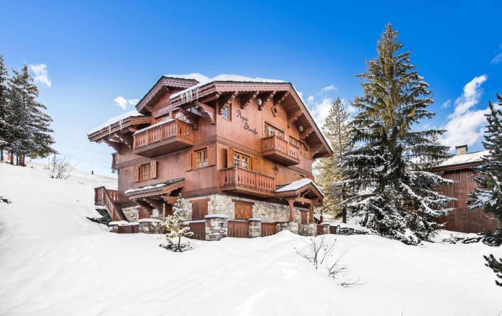 una gran casa de madera en la nieve en Résidence Agathe Blanche - Chalets pour 12 Personnes 984, en Courchevel