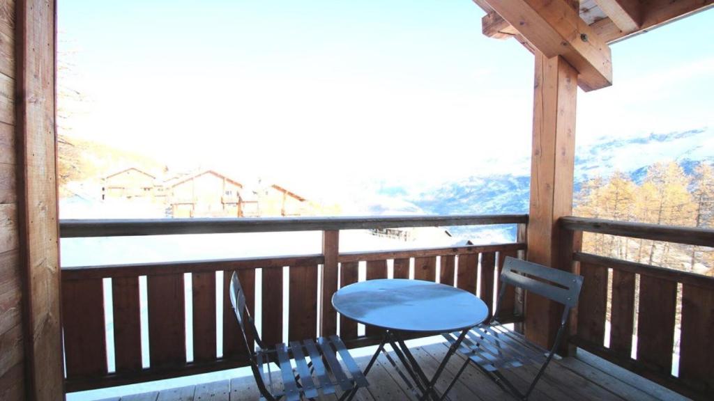 a table and chairs on a balcony with a view at Résidence Dame Blanche - Chalets pour 8 Personnes 644 in Narreyroux