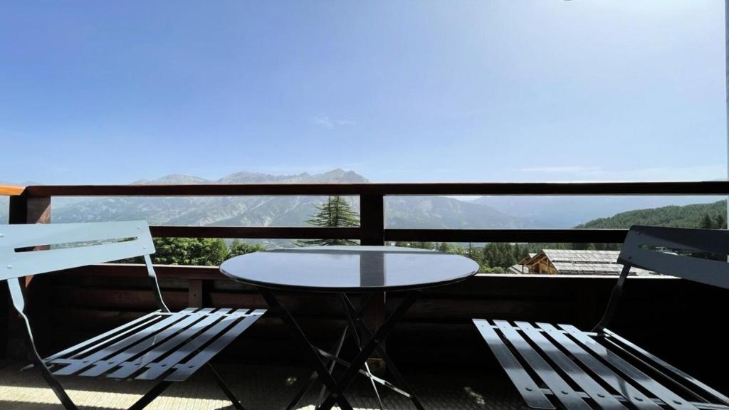 a table and two chairs on a balcony with a view at Résidence Dame Blanche - 2 Pièces pour 6 Personnes 664 in Narreyroux
