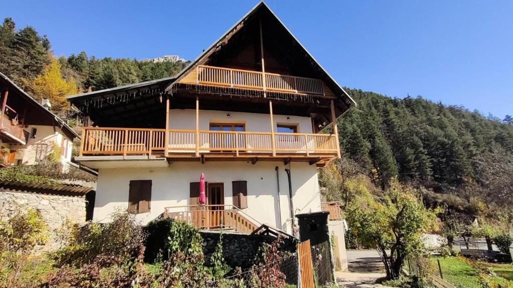 a large house with a balcony on a mountain at Résidence Le Refuge De Lulu-vallouise-pelvoux - Chalets pour 16 Personnes 564 in Pelvoux