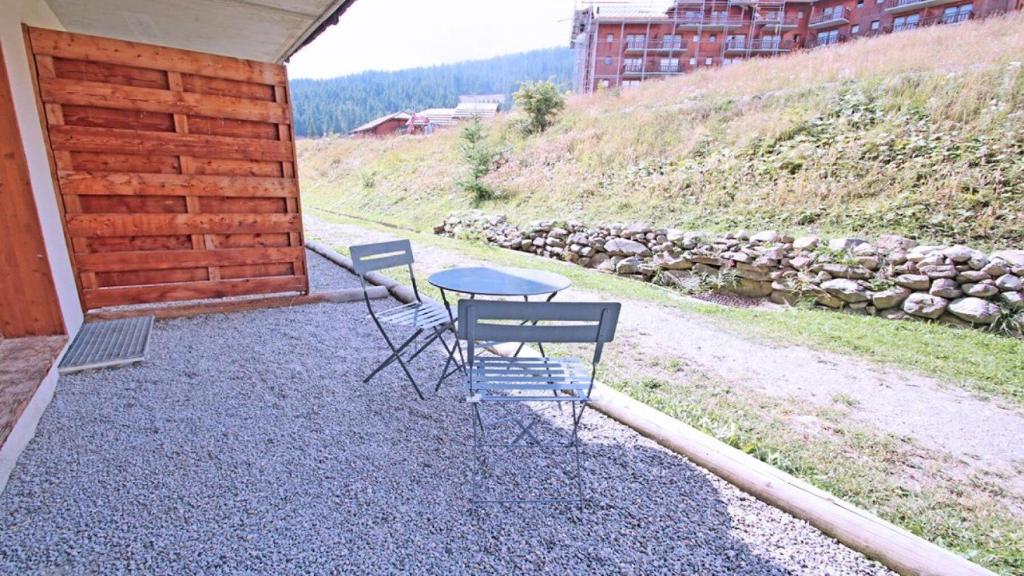 two chairs and a table sitting on a patio at Résidence Dame Blanche - 2 Pièces pour 6 Personnes 394 in Narreyroux