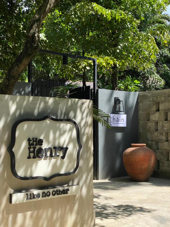 The Henry Resort Boracay في بوراكاي: لافته للمكتبه بها مزهريه بجانب سياج